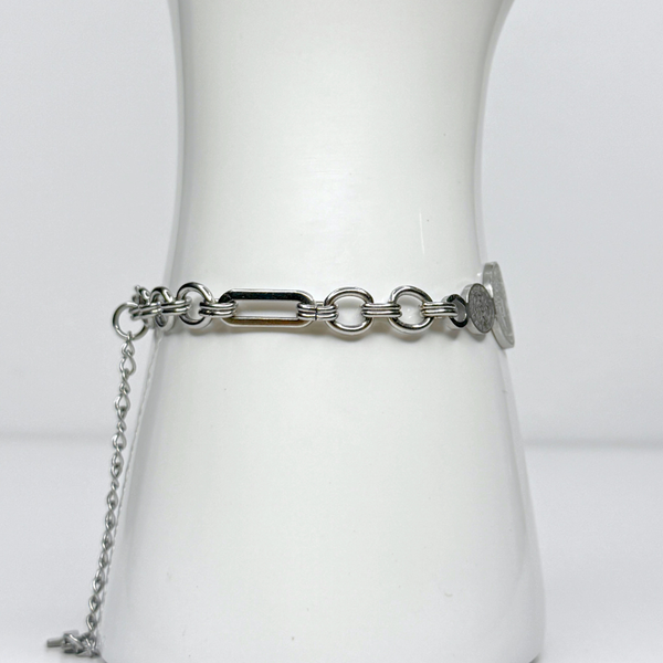 Silver chain belt on a mannequin with a plain white background